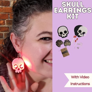 May include: A skull earrings kit with video instructions. The kit includes skull-shaped earrings, LEDs, and other components. The earrings are white with black accents. The text "SKULL EARRINGS KIT" is displayed at the top of the image.