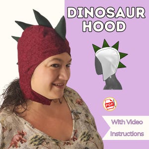 May include: A burgundy dinosaur hood with green spikes, as seen in the image. The text "DINOSAUR HOOD" is displayed in white. The image also includes a PDF icon and the words "With Video Instructions".