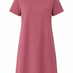 May include: A solid dusty rose colored t-shirt dress featuring a round neckline, short sleeves, and a straight hemline. The garment has a simple, unadorned design with a consistent matte texture throughout the fabric, providing a clean and uniform look.
