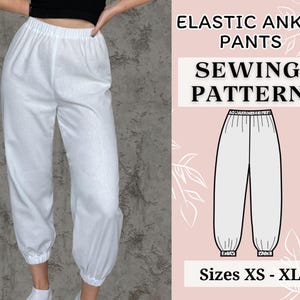May include: A sewing pattern for elastic ankle trousers. The pattern includes instructions for sizes XS to XL. The image shows a white pair of trousers on a model.