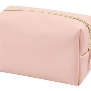 May include: A pale pink zippered makeup bag with a gold zipper.
