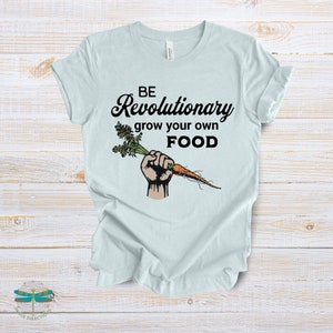 May include: A light blue t-shirt with the text "BE Revolutionary grow your own FOOD" and a cartoon image of a hand holding a carrot.
