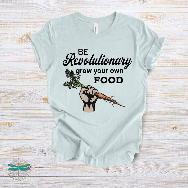 May include: A light blue t-shirt with the text "BE Revolutionary grow your own FOOD" and a cartoon image of a hand holding a carrot.