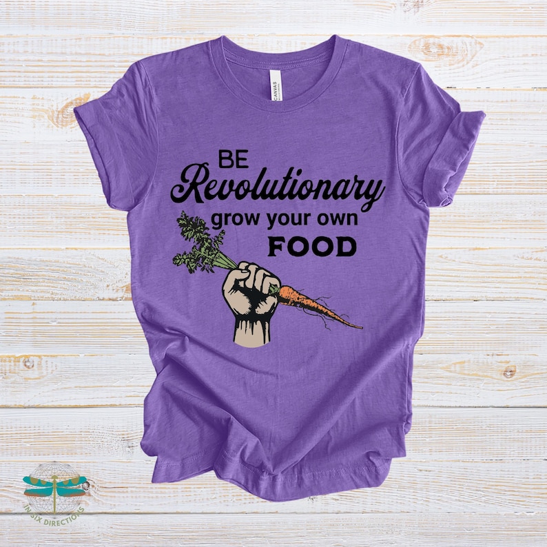 May include: Purple t-shirt with black text that reads "Be Revolutionary grow your own FOOD". A cartoon hand holding a carrot is printed on the shirt.