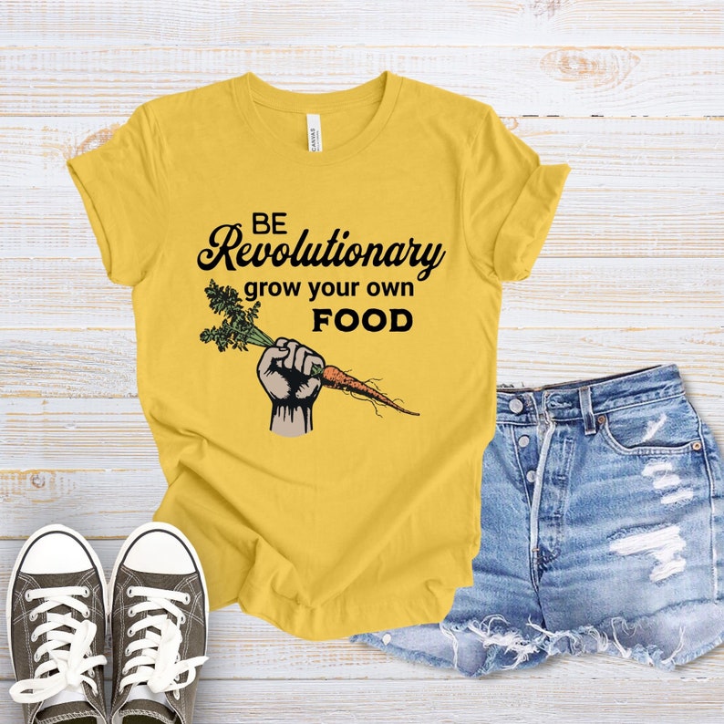 May include: Yellow t-shirt with the text "BE Revolutionary grow your own FOOD" and a cartoon hand holding a carrot.