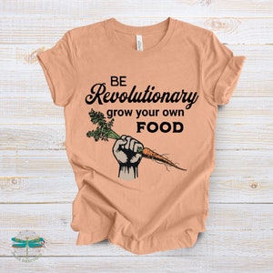 May include: A peach colored t-shirt with the text "BE Revolutionary grow your own FOOD" and a cartoon image of a fist holding a carrot.