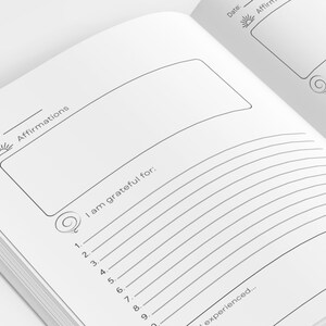 May include: A blank journal page with a lined section for writing down things you are grateful for. The page also has a section for writing affirmations. The journal has a simple design with a sun icon at the top of the page.