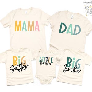 May include: A collection of matching cream-colored family shirts and a onesie. The shirts read "MAMA", "DAD", "BIG sister", and "BIG brother" in colorful block letters. The onesie says "Little brother". The brand name "LittleAndBebe" is in the top right corner.
