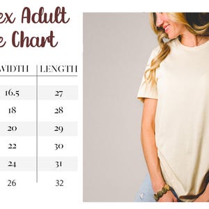 May include: Cream-colored unisex t-shirt with rolled sleeves. The image includes a size chart with measurements in inches for XS to 2XL sizes. The text on the chart reads "Unisex Adult Size Chart."