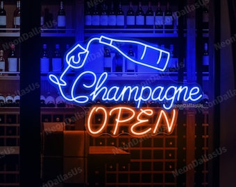May include: A neon sign with a blue bottle pouring champagne into a glass. The sign says "Champagne Open" in a cursive font. The sign is in front of a window with a wine cellar behind it.