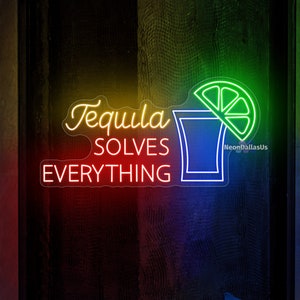 May include: Neon sign with a shot glass and lime wedge, with the text "Tequila Solves Everything".