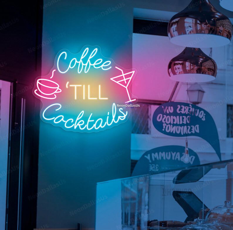May include: Neon sign with the text "Coffee 'Till Cocktails" in a blue, pink, and yellow gradient. The sign features a coffee cup and a cocktail glass.
