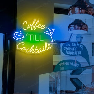 May include: Neon sign with yellow and green text that reads "Coffee 'Till Cocktails" with a white coffee cup and martini glass graphic.