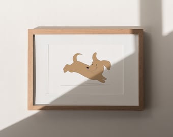 May include: A framed print featuring a cartoon illustration of a dachshund dog in mid-air, appearing to run. The dog is light brown with a smiling expression. The frame is made of light-colored wood, and the background is white.