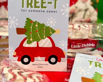 May include: A Christmas-themed greeting card with a red car carrying a green Christmas tree. The card reads "A Christmas TREE-T for someone sweet" with snowflakes. The text "Merry Christmas! From." is also visible.