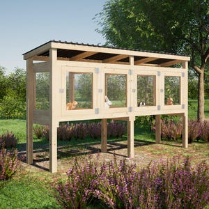 May include: A wooden rabbit hutch with three separate cages, each with a door and a wire mesh front. The hutch is raised off the ground on four legs and has a roof with a slight overhang. The hutch is in a grassy area with some bushes in the background.