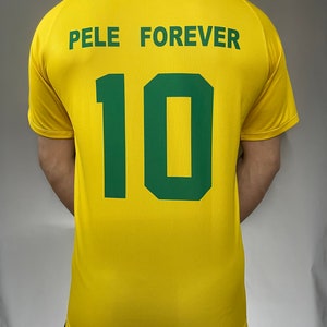 May include: Yellow soccer jersey with green text that reads "Pele Forever" and the number "10" on the back.