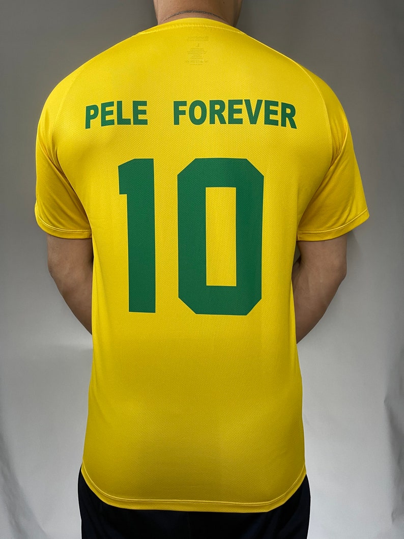 May include: Yellow soccer jersey with green text that reads "Pele Forever" and the number "10" on the back.