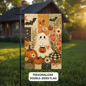 May include: A rectangular garden flag featuring a patchwork design with a central white ghost wearing an orange patterned bow, holding a jack-o'-lantern bucket. The flag includes pumpkins, autumn leaves, flowers, bats, and a crescent moon.