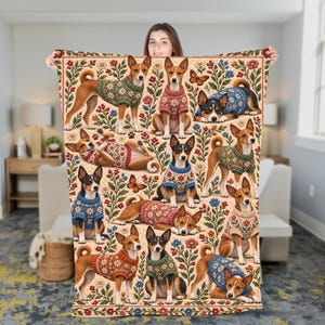 May include: A rectangular throw blanket featuring a repeating pattern of Basenji dogs wearing floral sweaters, interspersed with colorful flowers and butterflies on a cream background. The dogs are depicted in various poses.