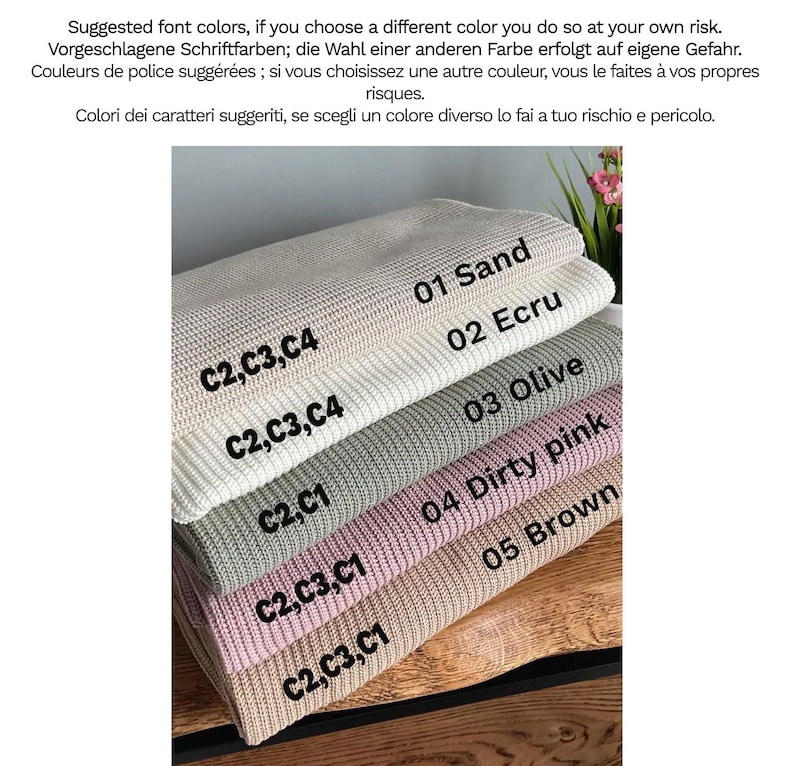 May include: A stack of five folded knitted blankets in various colours labelled 01 Sand, 02 Ecru, 03 Olive, 04 Dirty pink, and 05 Brown. Each blanket features a textured waffle-knit pattern and includes printed text codes C2, C3, C4, or C1.