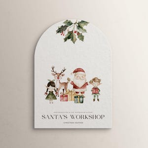 Peut inclure: Illustration aquarelle de P&egrave;re No&euml;l, un lutin, un renne et une fille tenant des cadeaux. L'illustration est sur fond blanc avec un brin de houx en haut. Le texte "Santa's Workshop Christmas Edition" est en bas de l'image.