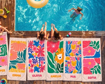 May include: Six rectangular beach towels with colorful floral and animal patterns, each personalized with names including Harper, Emma, Olivia, Amelia, Mia, and Sofia, laid out on a wooden pool deck beside a swimming pool with a yellow inner tube.