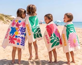 May include: Four off-white beach towels featuring colorful graphic prints and personalized names. One towel has a blue bird and pink flowers with the name OLIVIA, one has green leaves and AMELIA, one has red flowers and SOFIA, and one has a pink flower and HARPER.