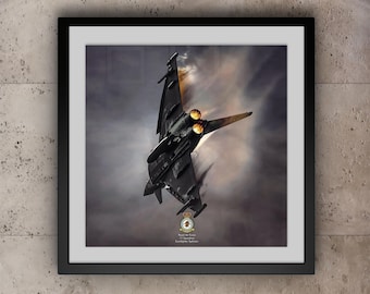 May include: A black and gray Eurofighter Typhoon jet aircraft with afterburners engaged, flying through a cloudy sky. The aircraft is from the Royal Air Force 11 Squadron, with the text "Royal Air Force 11 Squadron, Sunfighter Typhoon" visible on the bottom of the image.