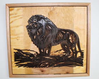 May include: A framed wood wall art piece featuring a black silhouette of a lion with a detailed mane, carved into the wood. The lion is standing on a textured surface, with a wood grain background.