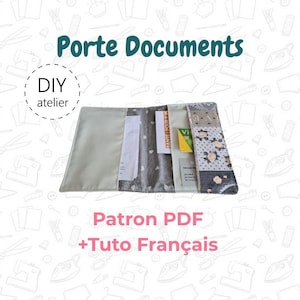 May include: A fabric document holder featuring a multi-panel design with a light gray interior, a gray heart-patterned section, and a floral print panel. The holder contains white papers and cards. Text reads: Porte Documents, DIY atelier, Patron PDF +Tuto Français.