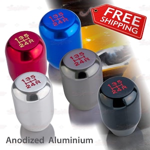 May include: An assortment of anodized aluminum shift knobs in various colors: red, blue, silver, gray, and black. Each knob features the gear pattern 135/24R in red lettering. The text "Anodized Aluminium" is at the bottom.