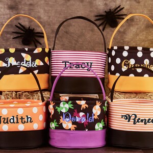 May include: Six Halloween trick-or-treat bags with different patterns and personalized names. The bags are orange, black, white, and purple with candy corn, polka dots, stripes, and candy designs.