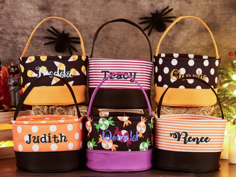 May include: Six Halloween trick-or-treat bags with different patterns and personalized names. The bags are orange, black, white, and purple with candy corn, polka dots, stripes, and candy designs.