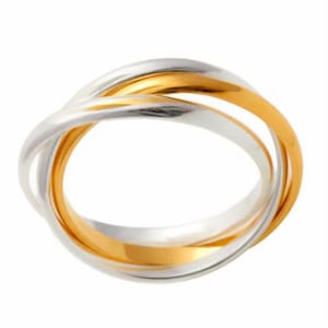 May include: A tri-color ring with three intertwined bands. The ring features a combination of silver and gold tones, creating a striking contrast. The bands are smooth and polished, reflecting light. This piece of jewelry is a stylish accessory.