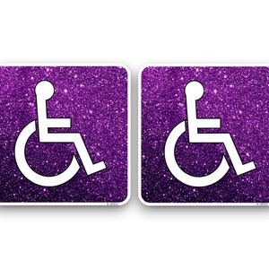 May include: Two square signs with purple glitter and white wheelchair accessibility symbols.