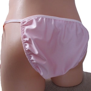 May include: A set of three ceramic mugs with a speckled, matte finish. Each mug features a different color: light blue, cream, and gray. The mugs have a simple, modern design with a rounded shape and a comfortable handle.