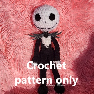 May include: Crocheted amigurumi doll of Jack Skellington from the Nightmare Before Christmas film. The doll is wearing a black suit with a white bow tie and has a white face with black eyes and a stitched smile. The doll is sitting on a pink fluffy surface. The text "Crochet pattern only @Twisted_Weaver" is below the doll.
