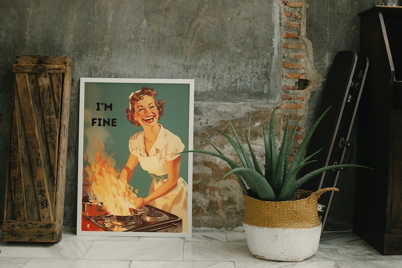 May include: A vintage-style poster with a woman in a white dress standing in front of a stove with flames coming out of the pots. The poster says "I'm Fine" in bold black letters.