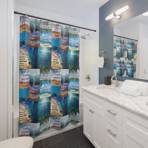 May include: A blue and white shower curtain with a beach and ocean theme. The curtain features various Bible verses about the sea and God's creation. The curtain is hung in a bathroom with a white vanity and a mirror.