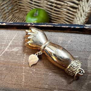 Gold fist charm deals