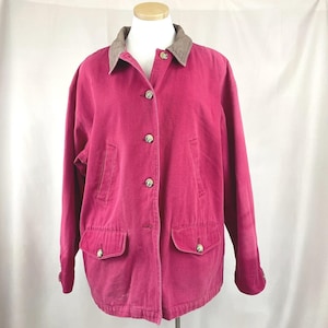 May include: A magenta-colored jacket with a brown and tan plaid collar. The jacket has four front pockets, button closures, and a classic design. The jacket is displayed on a mannequin.