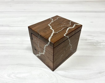 May include: A wooden box with a dark brown finish and a white crackle design on the top and sides.