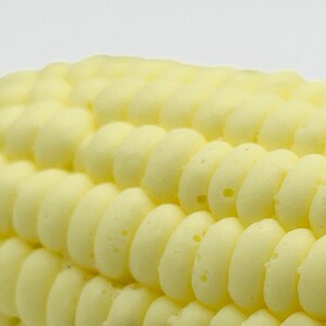 Closeup texture of the corn on the cob soap showing the realistic texture of the soap. The soap has individual kernels just like on an actual corn on the cob. The soap is a novelty that looks just like the real thing.