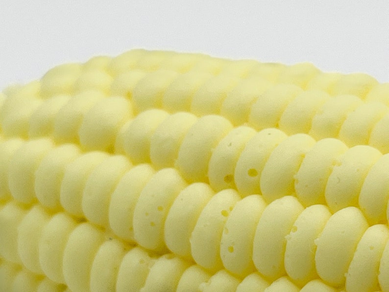 Closeup texture of the corn on the cob soap showing the realistic texture of the soap. The soap has individual kernels just like on an actual corn on the cob. The soap is a novelty that looks just like the real thing.