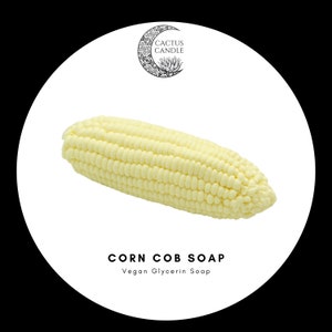 May include: A yellow corn cob shaped vegan glycerin soap. The soap is on a white background with the text "CORN COB SOAP" and "Vegan Glycerin Soap" below it.