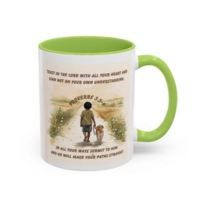 May include: White ceramic mug with a green interior and handle. The mug features an illustration of a child walking with a dog on a path, with text from Proverbs 3:5-6. The mug is a standard size for hot beverages.