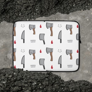 May include: White laptop sleeve featuring a repeating pattern of cartoon axes, knives, and blood drops. The text "Murder Buddies" is printed on the sleeve.