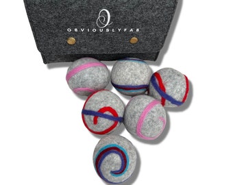 May include: A set of six gray felt dryer balls with colorful stripes and swirls. The balls come in a gray felt bag with a handle and the text "OBVIOUSLYFAB" printed on the front.