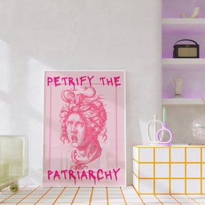 May include: A pink framed print with the text "Petrify the Patriarchy" in pink lettering. The print features a pink illustration of a woman's head with snakes in her hair.